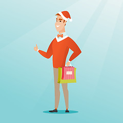 Image showing Man in santa hat shopping for christmas gifts.