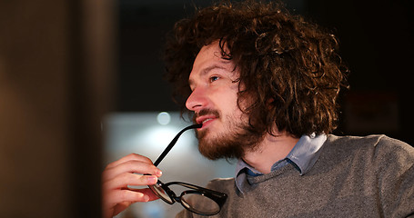 Image showing man working on computer in dark office