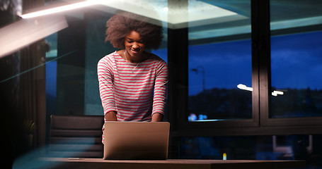 Image showing black businesswoman using a laptop in night startup office