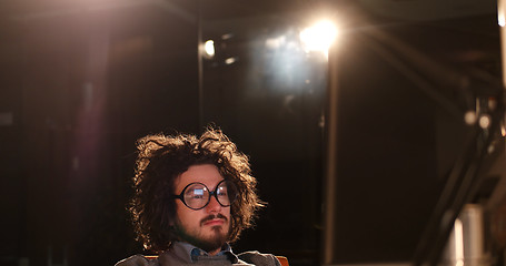 Image showing man working on computer in dark office