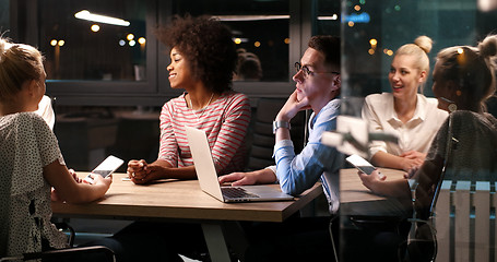 Image showing Multiethnic startup business team in night office