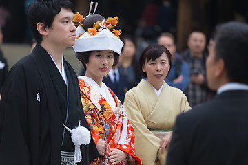 Image showing Young happy groom and bride during japanese traditional wedding ceremony at Meiji-jingu shrine in Tokyo, Japan on November 23, 2013.