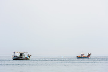 Image showing Two small fishing boat at sea surface