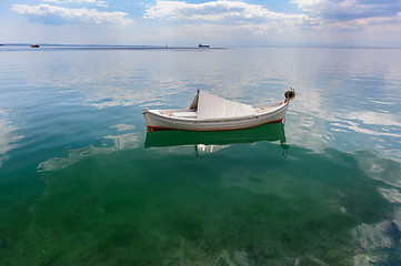 Image showing Small fishing boat at sea surface