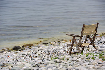 Image showing old wooden foldable chair at the beach