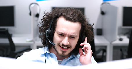 Image showing male call centre operator doing his job