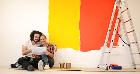 Image showing Happy young couple relaxing after painting