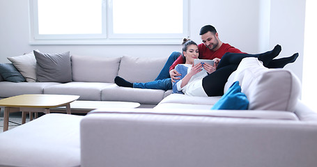 Image showing couple relaxing at  home with tablet computers