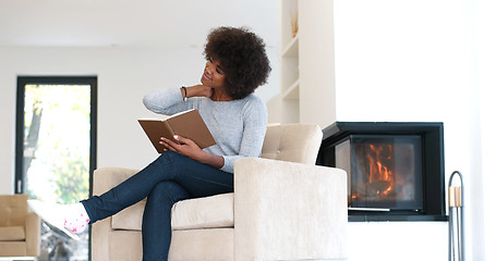 Image showing black woman at home reading book