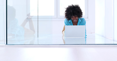 Image showing black women using laptop computer on the floor