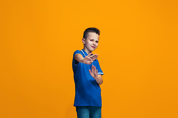 Image showing Young serious thoughtful teen boy. Doubt concept.