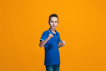 Image showing Beautiful teen boyl looking suprised isolated on orange