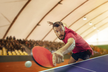 Image showing The table tennis player serving