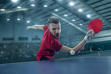 Image showing The table tennis player serving