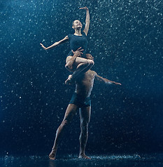 Image showing Young couple of ballet dancers dancing unde rwater drops