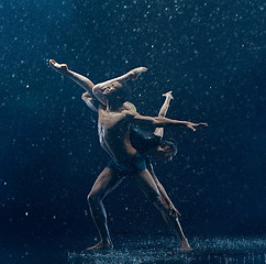 Image showing Young couple of ballet dancers dancing unde rwater drops