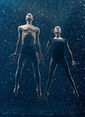 Image showing Young couple of ballet dancers dancing unde rwater drops