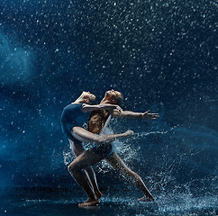 Image showing Young couple of ballet dancers dancing unde rwater drops