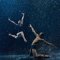 Image showing Young couple of ballet dancers dancing unde rwater drops