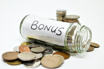 Image showing Bonus lable in a glass jar with coins spilling out