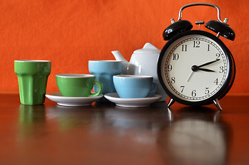 Image showing Alarm clock with colorful tea set