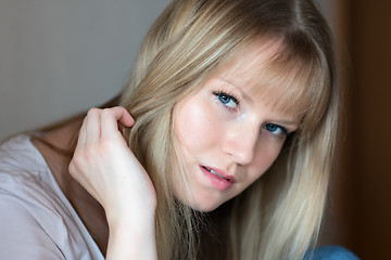 Image showing Sad girl is sitting on the floor