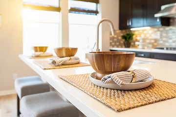 Image showing Wooden Bowl Place Settings on Kitchen Island Abstract