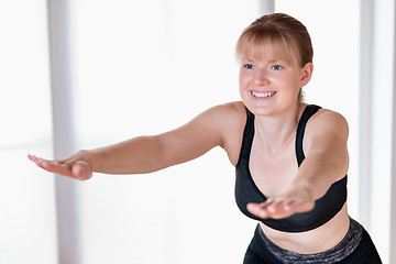 Image showing Girl doing squat exercises