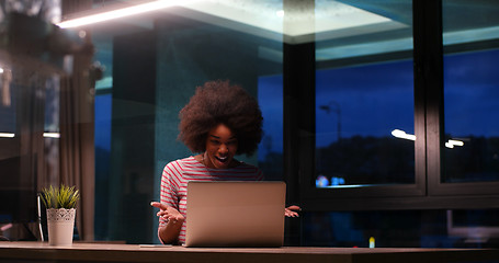 Image showing black businesswoman using a laptop in night startup office