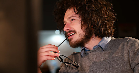 Image showing man working on computer in dark office