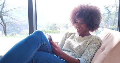 Image showing african american woman at home using digital tablet