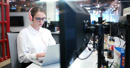 Image showing businesswoman using a laptop in startup office