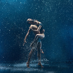 Image showing Young couple of ballet dancers dancing unde rwater drops
