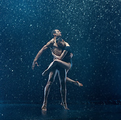 Image showing Young couple of ballet dancers dancing unde rwater drops