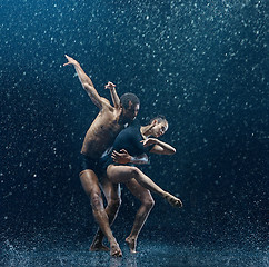 Image showing Young couple of ballet dancers dancing unde rwater drops