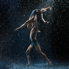 Image showing Young couple of ballet dancers dancing unde rwater drops