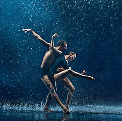 Image showing Young couple of ballet dancers dancing unde rwater drops