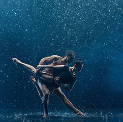 Image showing Young couple of ballet dancers dancing unde rwater drops