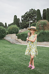 Image showing Little girl just swing golf ball on golf course fairway