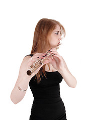 Image showing Woman standing, playing the flute in close up