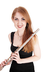 Image showing Woman standing, holding her flute and smiling