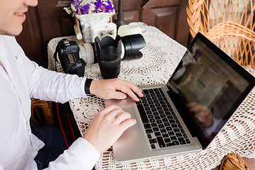 Image showing man working with laptop computer and sitting on sofa