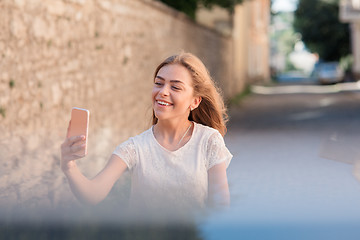 Image showing Girl take selfie from hands with phone on summer city