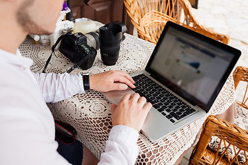 Image showing man working with laptop computer and sitting on sofa