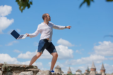 Image showing young man throws a laptop