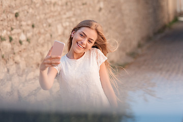 Image showing Girl take selfie from hands with phone on summer city