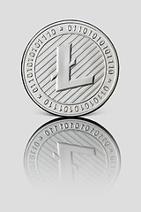 Image showing Silver coin Litecoin on white glossy background. Business and technology concept