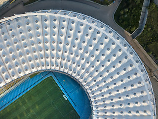 Image showing KYIV, UKRAINE - July 19, 2018. NSC Olimpiysky the birds eye view from drone of construction the stadium roof, green football field, tribunes of complex.