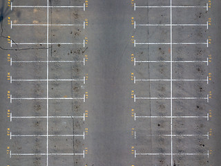 Image showing Asphalt floor with parking lot at city center, vacant parking lot. Parking lane painting on floor with numbered places.