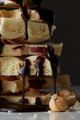 Image showing syrop pouring onto a piece of chocolate